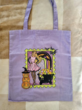Load image into Gallery viewer, Tote bag with Halloween-themed design featuring a witch and pumpkins on a purple background.