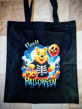 Load image into Gallery viewer, Black tote bag with Halloween-themed design featuring a bear in a costume on a checkered floor.