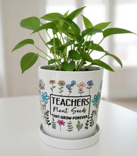 Load image into Gallery viewer, Potted plant in a decorative pot with 'Teachers Plant Seeds That Grow Forever' text on a white surface.