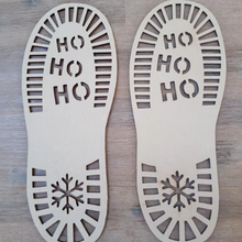 Load image into Gallery viewer, Wooden shoe insoles with 'HO HO HO' text and snowflake design on a wooden surface