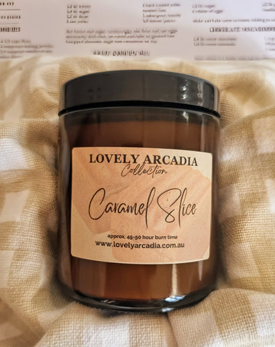 Candle jar with 'Lovely Arcadia' label on a textured beige fabric background