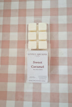 Load image into Gallery viewer, Pack of Lovely Arcadia Sweet Caramel wax melts on a checkered tablecloth

