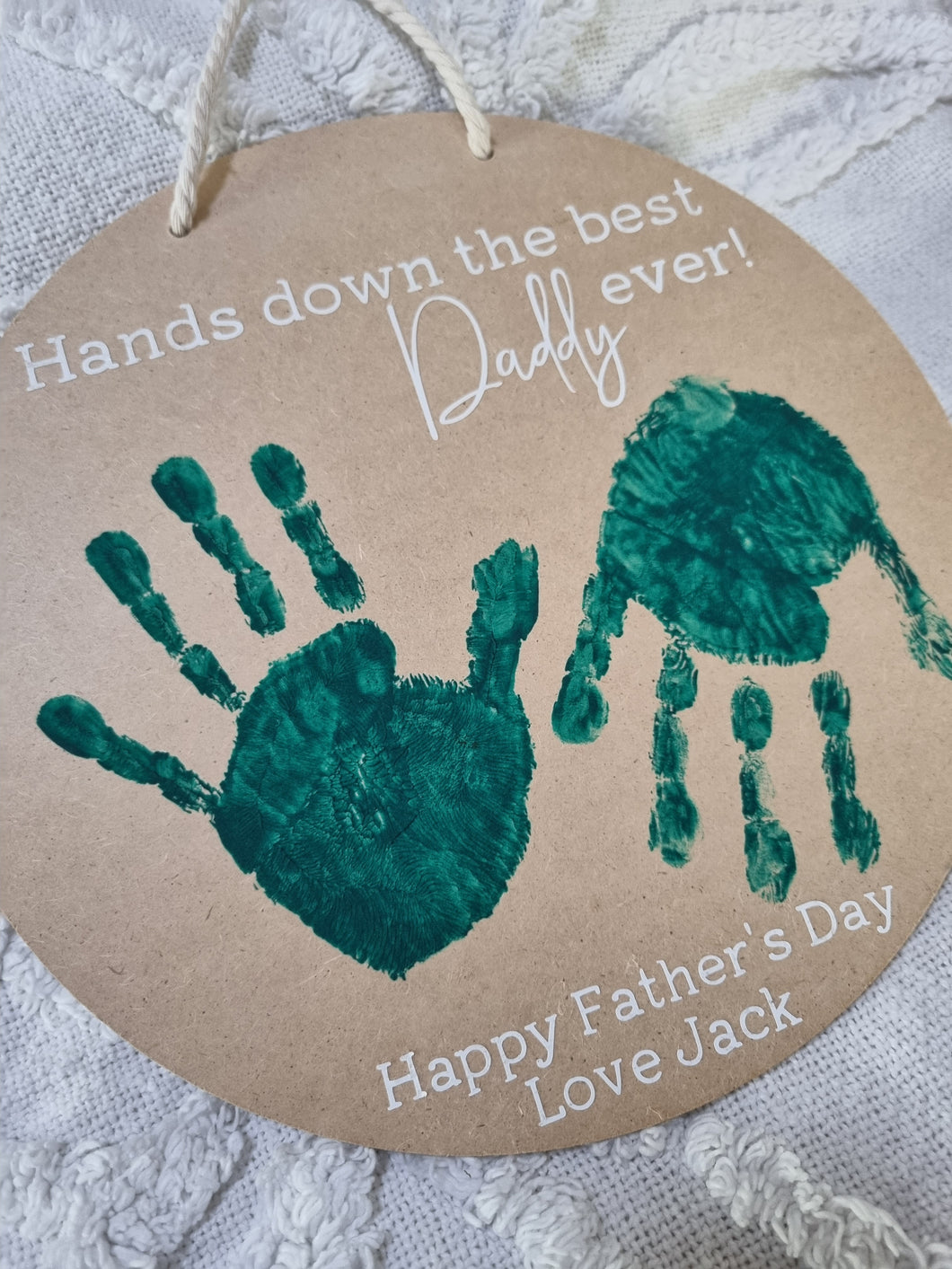 A personalized wooden hanging sign with painted handprints and the text 'Hands down the best Daddy ever! Happy Father's Day Love Jack'.