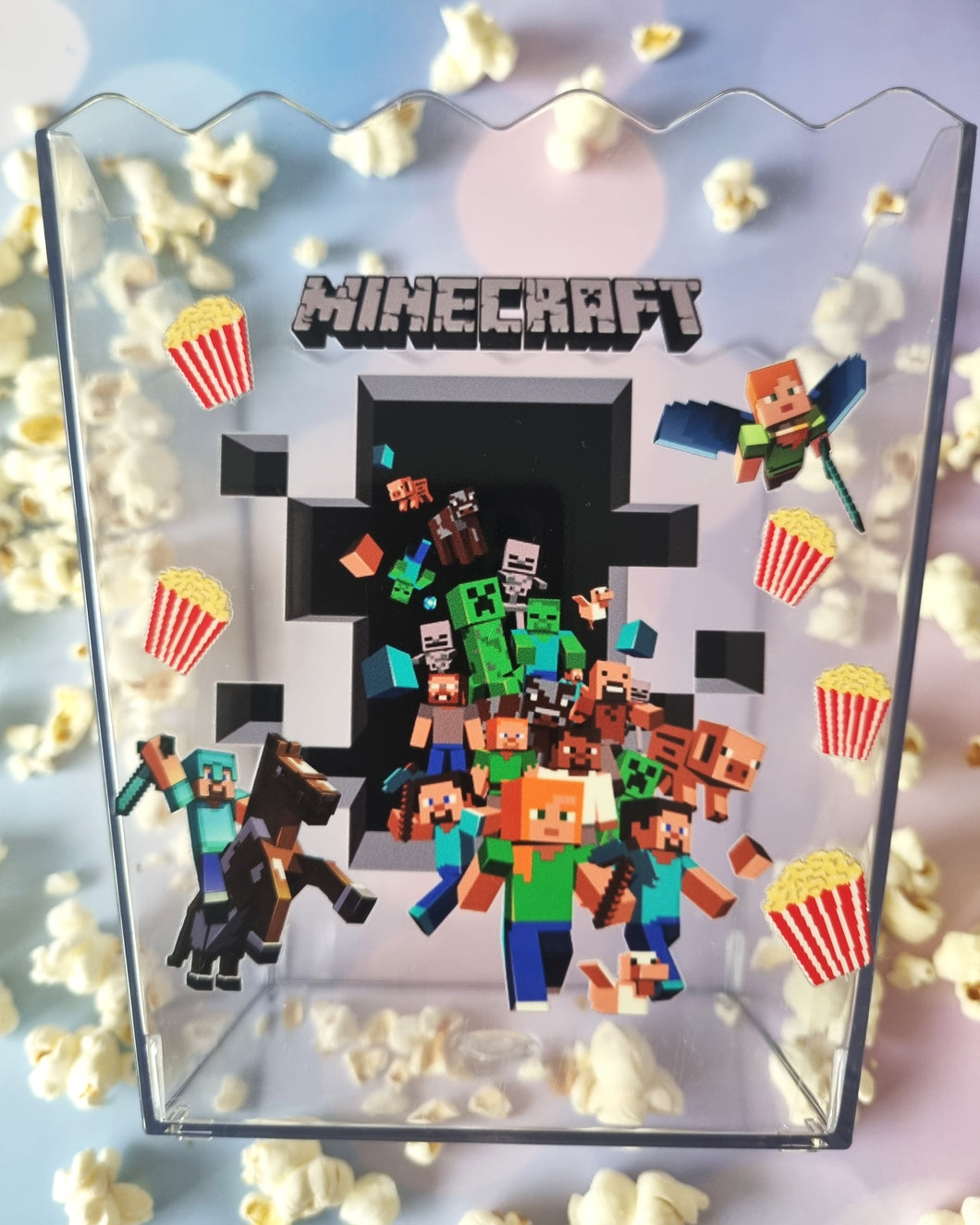 Minecraft-themed display with character figures and popcorn, featuring the Minecraft logo.
